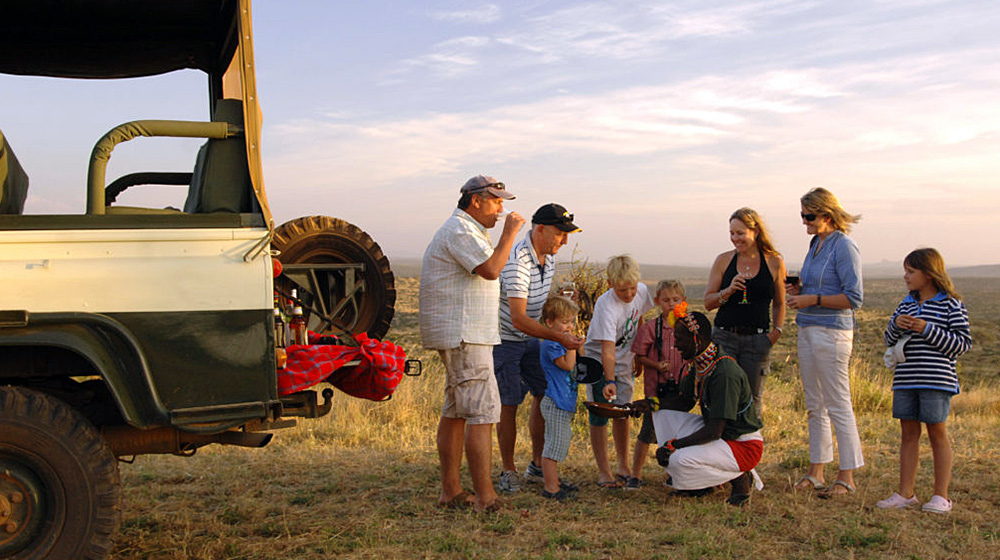 Family have down downer drinks on an African safari