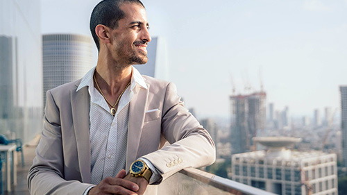 Man looking to the right with city backdrop