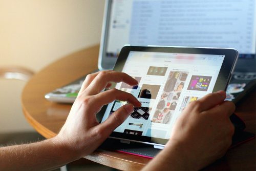 Left hand scrolls in on tablet screen